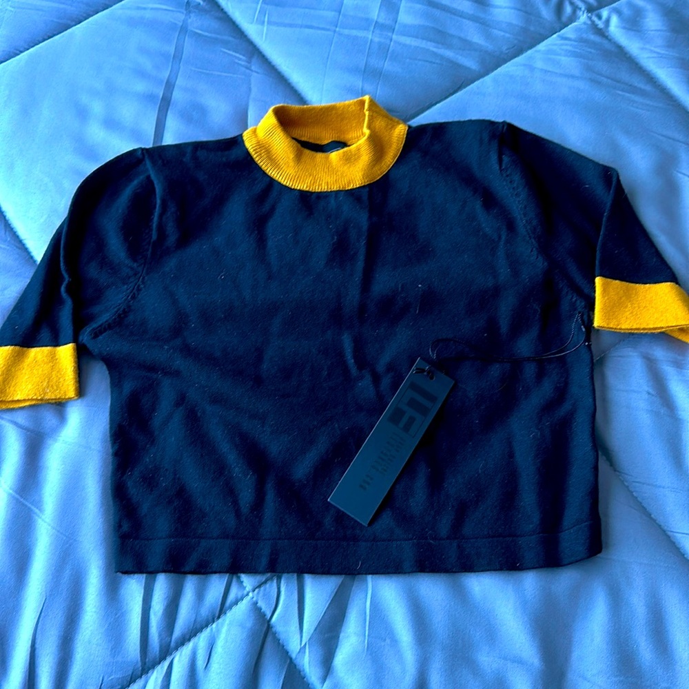 Black crop top with gold collar and sleeve caps
